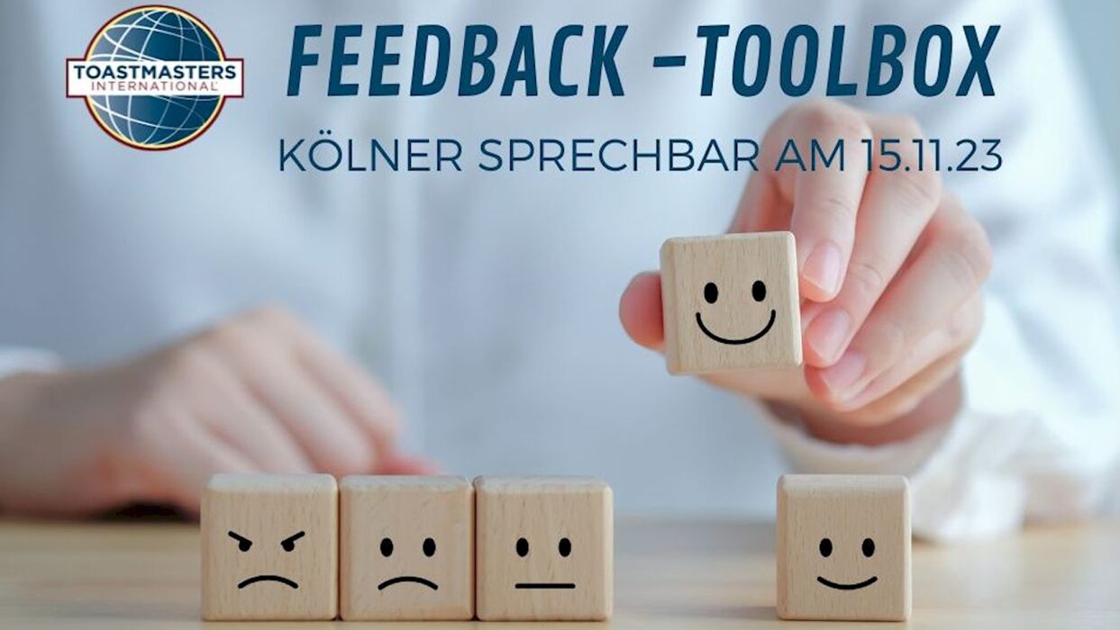 Grafik „Feedback-Toolbox“ mit einer Hand, die einen lächelnden Holzwürfel aus einer Reihe von Würfeln mit unterschiedlichen Gesichtsausdrücken auswählt, dazu das Toastmasters-International-Logo.